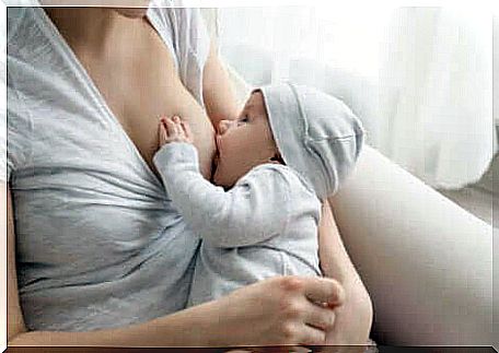 A baby sucking on the breast. 
