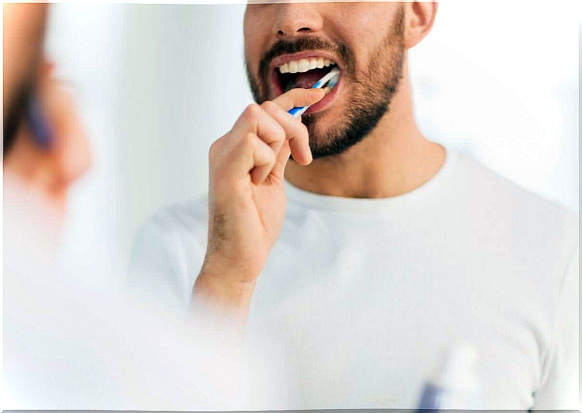 A man brushes his teeth.