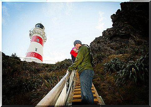 A father who climbs the stairs of a lighthouse