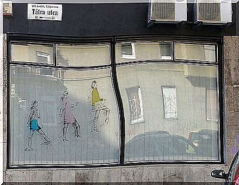 Shop window with people going up a staircase