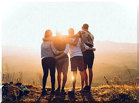 friends standing at sunrise